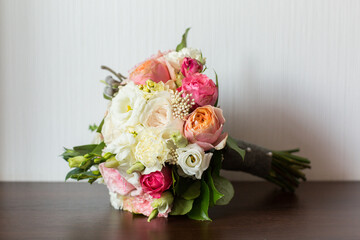 delicate wedding bouquet on background of room