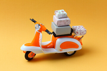 Toy motorbike delivering cardboard  boxes. Fast delivery service concept