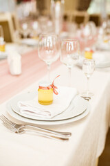 Jars with honey on wedding table. Gift for guests