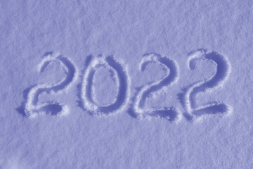 Happy new year 2022 sign text written with numbers from snow on snow surface