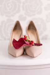 Wedding accessories: Bride's shoes, bouquet and red boutonniere from lily callas