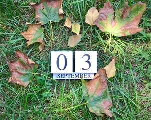 3rd of September sign on natural green grass. September day.