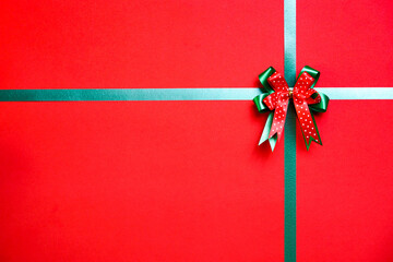 Christmas background with green ribbon and copy space. Decorative gift box. Top view shot