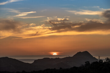 Stunning sunset over the Lybian Sea from hills above the Plakias village, Southern Crete, Greece