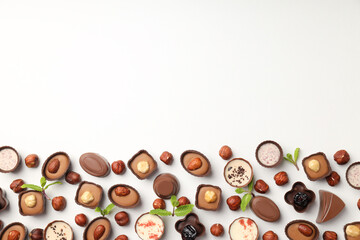 Flat lay composition with chocolate candies on white background