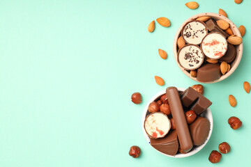Concept of sweets with chocolate candies on mint background