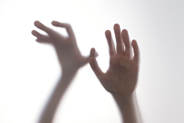 Silhouette scared boy stand behind glass door. Teen problems, negative emotions concept.