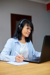 Senior woman student learning language, watching online course