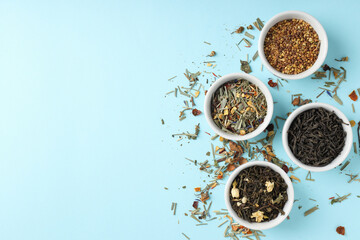 Concept of cooking tea with different types of tea on blue background