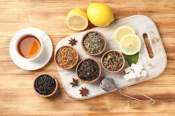 Concept of cooking tea with different types of tea on wooden background