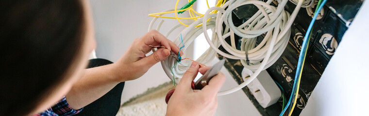 Top view of unrecognizable female technician installing lan network