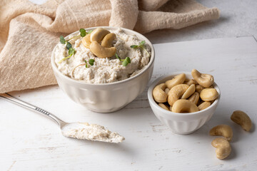 Fermented nut spread for vegan diet, bowl with cashew cheese. - obrazy, fototapety, plakaty
