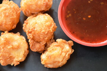 crispy fried squid ball dipping spicy and sweet sauce on plate