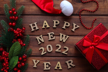 New Year congratulation with with inscription Happy New 2022 Year on wooden table. Top view, flat lay
