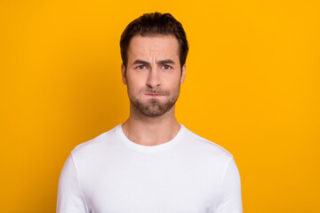 Photo of youngster man pouted cheeks grimace hold breath humorous isolated over yellow color...