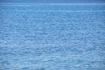 Obraz premium Closeup seascape surface of blue sea water with small ripple waves