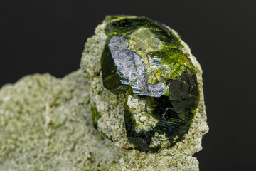 macro mineral stone Andradite on a black background