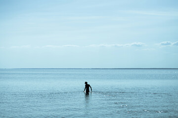 Silhouettes of a man in the sea
