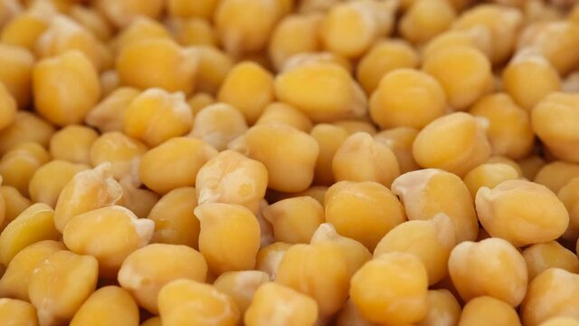 Boiled chickpeas close up, rotation. Process cooking snack with chickpeas. 4K UHD video