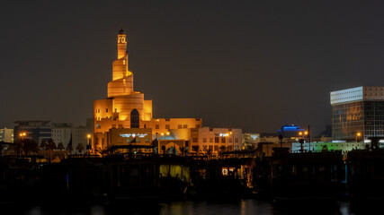 Fototapeta premium view of doha corniche during night along with fanar building.