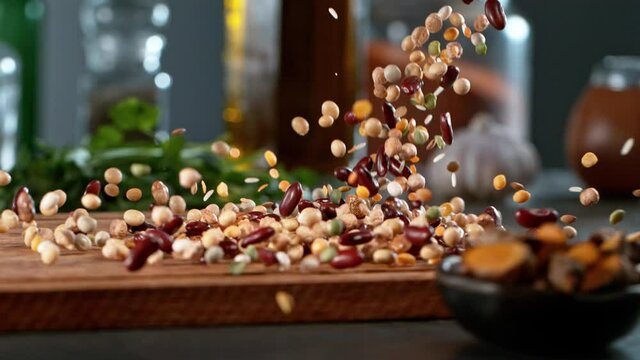 Super slow motion of rolling  legumes mix on wooden board. Filmed on high speed cinema camera , 1000 fps. Camera in motion control, follow the object.