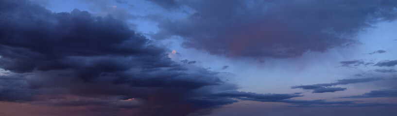 Fototapeta na wymiar Beautiful sunset with cumulus clouds Panoramic photography, the image is horizontally elongated, atmospheric phenomenon