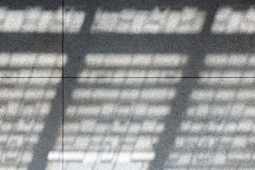 Abstract background of sunlight from windows on a gray tiled floor