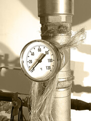 a big thermometer on the water pipe