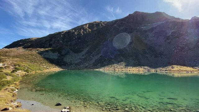 Amazing turquoise Hirscheben lake with great mountains in the background, very close to K&uuml;htai in Tyrol, Austria