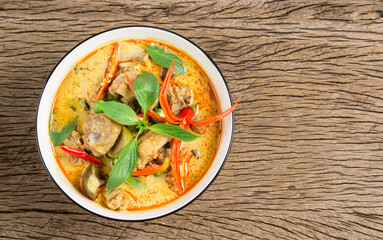 Thai food, green curry or red curry with chicken on the wooden floor, top view