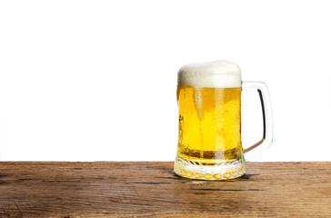 Beer glass with white beer foam on a dark wooden table background