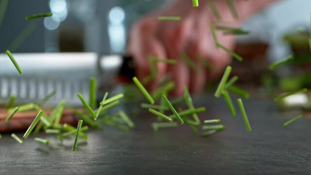 Super slow motion of cutting fresh chive with kitchen knife. Filmed on high speed camera, 1000 fps. Ramp speed effect.