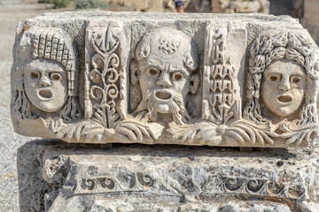 Ancient greek stone carvings in the yellow limestone rock. Facade of the building decoration in...