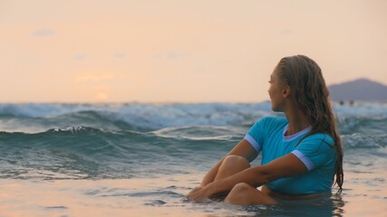 Fototapeta na wymiar Sexy hot woman sitting on water sea. Girl sit in turquoise swimsuit. Freedom paradise holiday vacation summer beach, seaside landscape concept