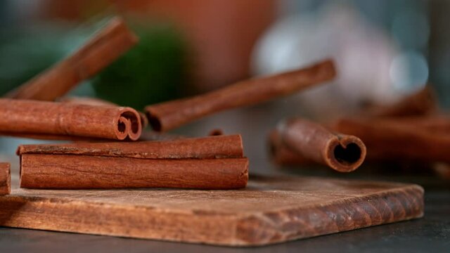Super slow motion of falling cinnamon spice on wooden board. Filmed on high speed cinema camera, 1000 fps. Speed ramp effect.