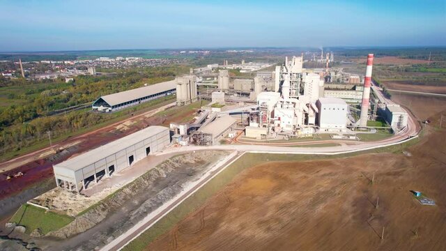 Cement plant with pipes. Сement production process and Industrial solution. factory with smoke pipe. Chimney smokestack emission. Poor environment. Ecology concept, air and environmental pollution.