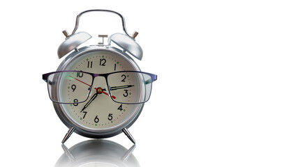 Classic alarm clock with glasses on white isolated background with reflection. Concept for business. Morning of a businessman. Time to work.