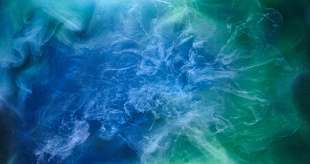 Blue green smoke on black ink background, colorful fog, abstract swirling ocean sea, acrylic paint pigment underwater