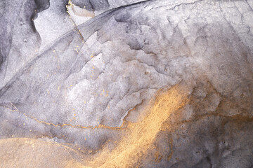 Luxury abstract dark background in alcohol ink technique, black gold liquid painting, scattered acrylic blobs and swirling stains, printed materials