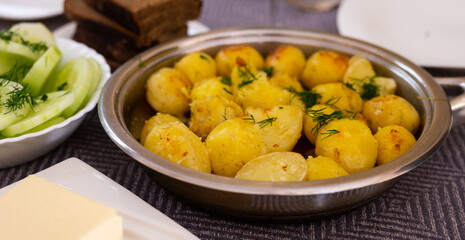 toasted young potatoes with dill in metal skillet