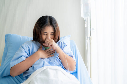 asian women is currently being treated in the hospital with a strong cough