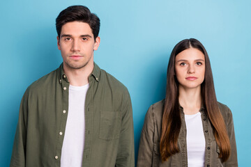 Photo of serious confident young lady guy dressed khaki shirts isolated blue color background