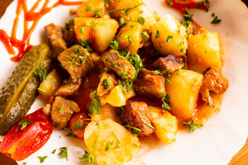 traditionally Russian dish of stewed potatoes with meat. Zharkoe po domashnemu