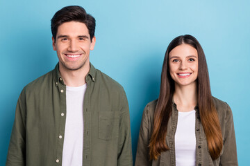 Photo of adorable attractive young lady guy wear green shirts smiling isolated blue color background