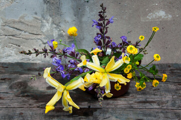 yellow and purple flowers in mug, vintage still life