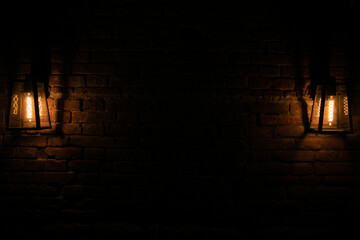 two old lanterns dim light dark wall