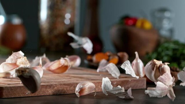 Super slow motion of rolling  garlic on wooden board. Filmed on high speed cinema camera, 1000 fps. Camera in motion control, follow the object. Speed ramp effect.