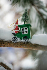 Naklejka premium Moscow, Russia, December 2021, New Year and relatives postcard, New Year's composition, Christmas composition, New Year's toy - Santa Claus is carrying a Christmas tree in a stagecoach