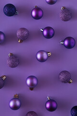 Purple baubles on a purple background. Christmas ornament monochrome concept. illuminated by purple light.