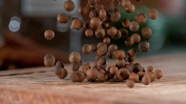 Super slow motion of falling allspice balls on wooden board. Filmed on high speed cinema camera, 1000 fps.